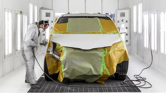 Collision Center Technician Painting a Vehicle | Toyota of Grand Rapids in Grand Rapids MI